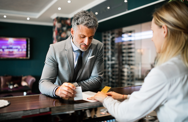 mature-businessman-at-hotel-reception